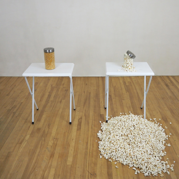 <b>Big Bang (Bliss Point I)</b><br>
TV tray tables and two glass jars, one filled with corn kernels, the second, broken, with the same amount of kernels, but popped.<br>
Dimensions variable<br>
2020