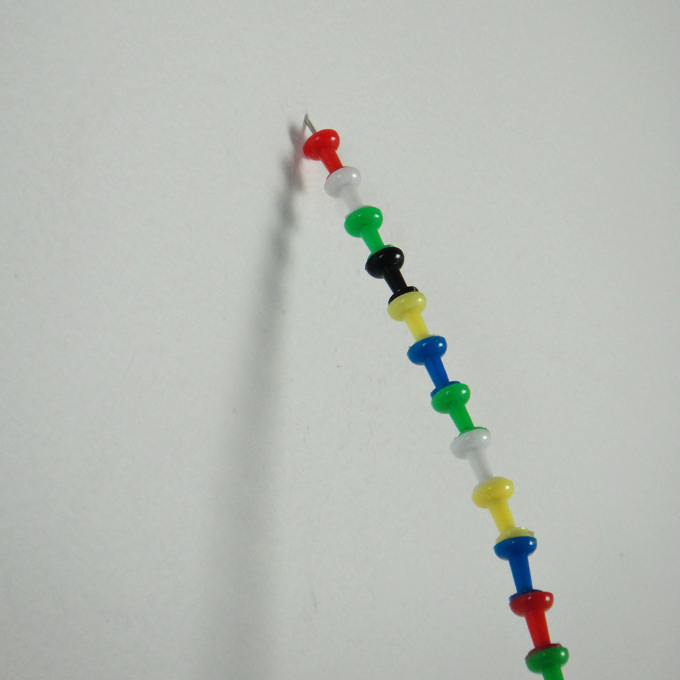 <b>Pin the Tail</b> (detail)<br>
One box of push pins connected together<br>
80 x 1 x 9 cm<br>
2011