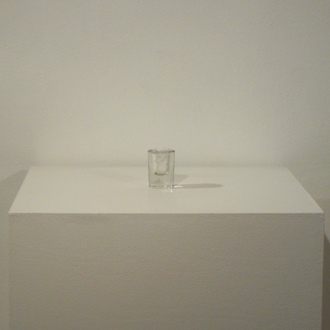 <b>Full of Yourself III</b><br>
Shot glass pulverized from the top down until full<br>
6 x 5 x 5 cm<br>
2010
