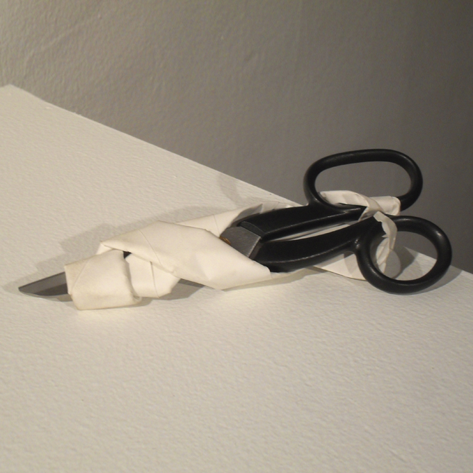 <b>The Art of War</b> (detail)<br>
Rocks, sheets of paper, and scissors.<br>
Dimensions variable<br>
2010